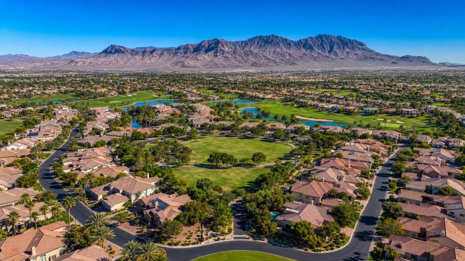 North Las Vegas master planned community with Aliante streetscape and mountain views — logistics and warehouse employment driving housing demand